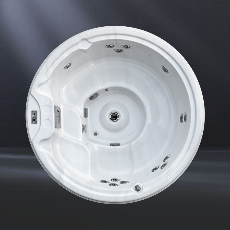 A round, white hot tub with multiple jets